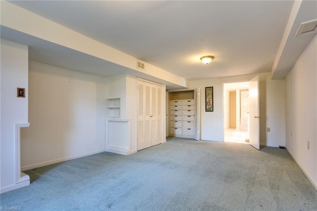 unfurnished bedroom featuring a closet and light colored carpet