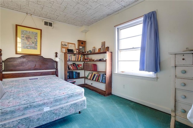 bedroom featuring dark carpet and multiple windows