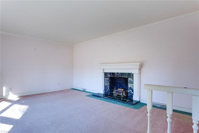 unfurnished living room with carpet floors, ornamental molding, and a fireplace