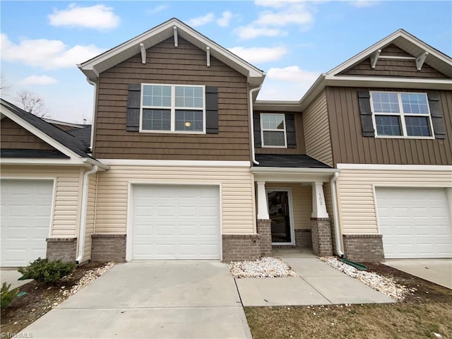 view of front of property with a garage, brick siding, and driveway