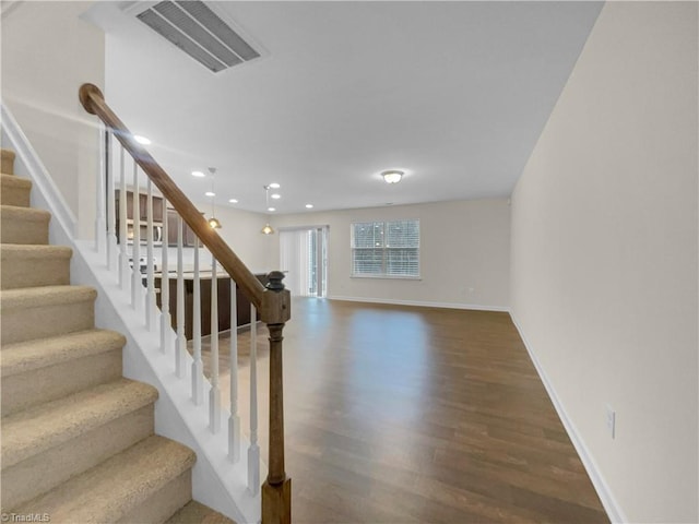 stairs with recessed lighting, wood finished floors, visible vents, and baseboards