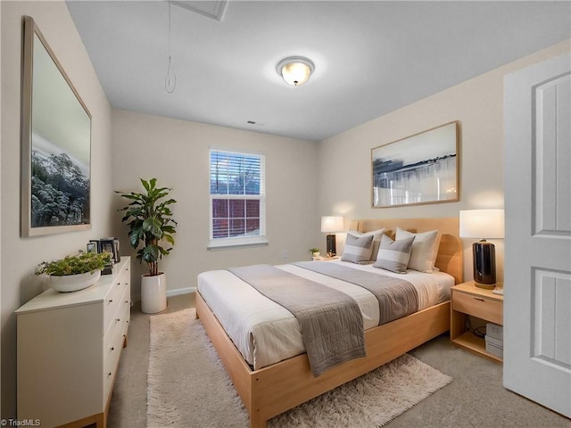 bedroom with light colored carpet and attic access