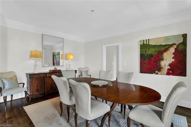 dining room with ornamental molding and wood finished floors