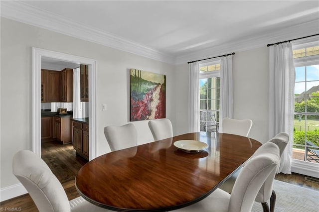 dining area with baseboards, ornamental molding, and dark wood-style flooring
