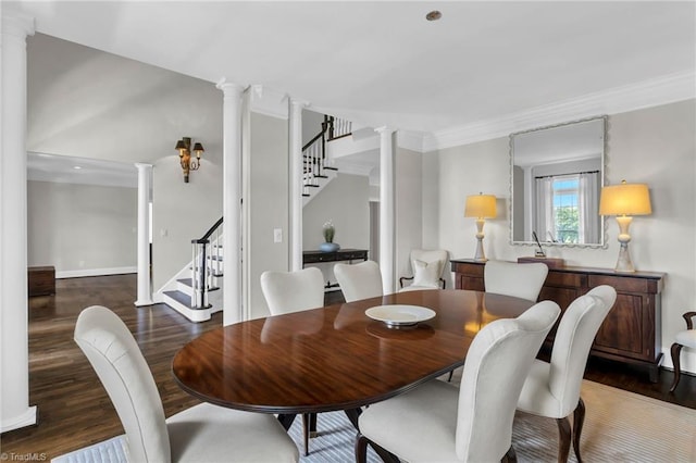 dining room with wood finished floors, stairway, baseboards, ornamental molding, and ornate columns