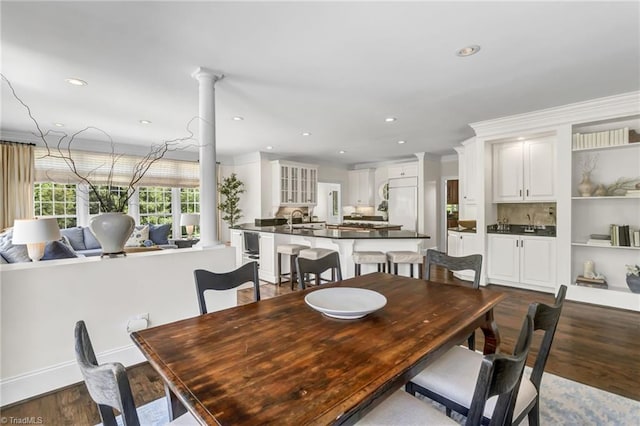 dining space featuring recessed lighting, baseboards, decorative columns, and dark wood-style flooring
