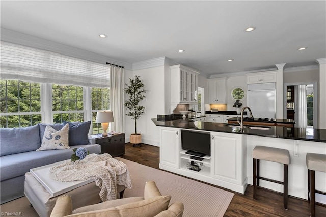 living room featuring recessed lighting, ornamental molding, and dark wood-style flooring
