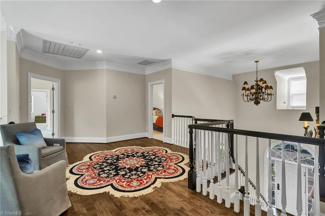hall featuring visible vents, wood finished floors, baseboards, a notable chandelier, and recessed lighting
