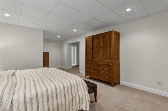 bedroom with baseboards, recessed lighting, a paneled ceiling, and light carpet