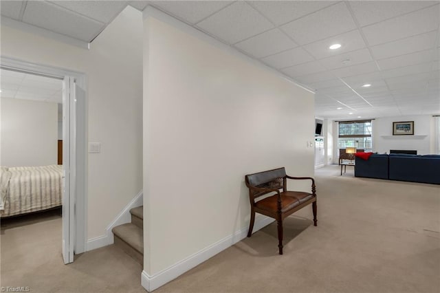corridor with recessed lighting, carpet flooring, baseboards, and a drop ceiling
