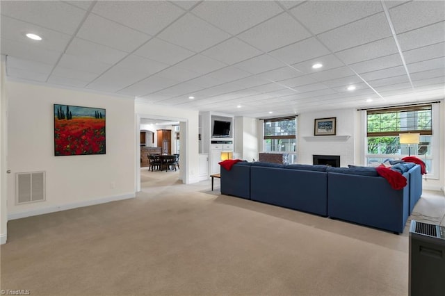 living area with light colored carpet, visible vents, a fireplace, baseboards, and recessed lighting