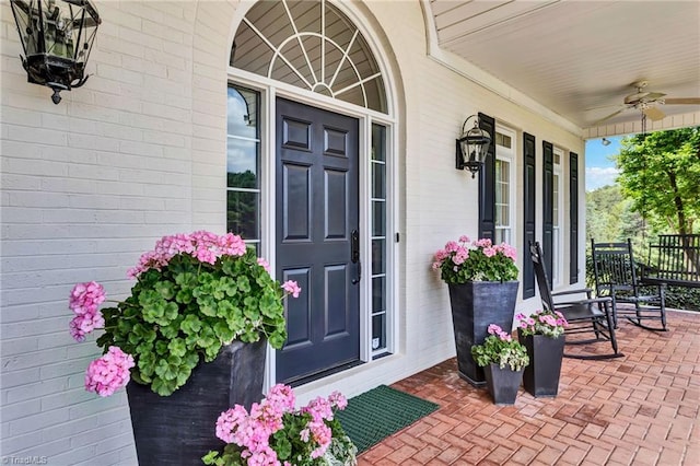 property entrance with a porch and ceiling fan