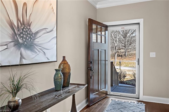 foyer featuring baseboards, dark wood-style flooring, and crown molding