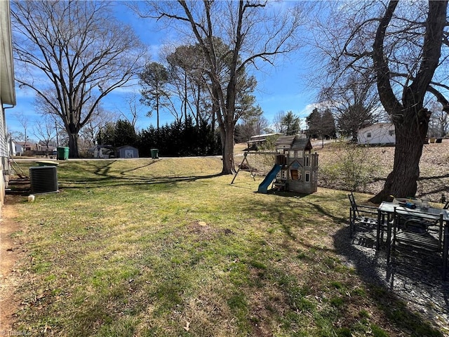 view of yard featuring playground community and central AC