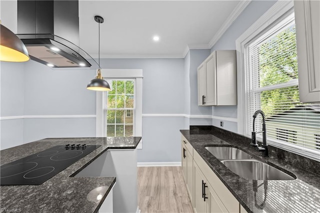 308 Worrell St, Thomasville, NC 27360 - kitchen with extractor fan, black electric cooktop, light wood-style flooring, pendant lighting, and dark stone countertops