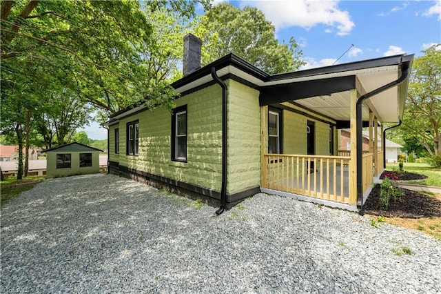 308 Worrell St, Thomasville, NC 27360 - view of home's exterior with a chimney and covered porch