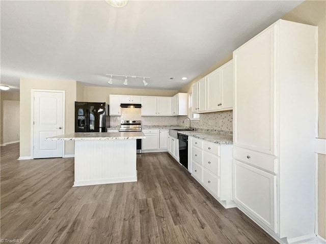 kitchen featuring sink, black appliances, a center island, and dark wood-type flooring