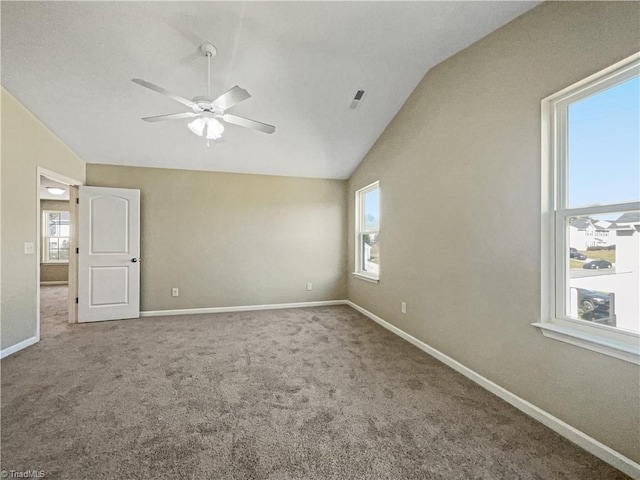 spare room featuring lofted ceiling, carpet floors, and ceiling fan