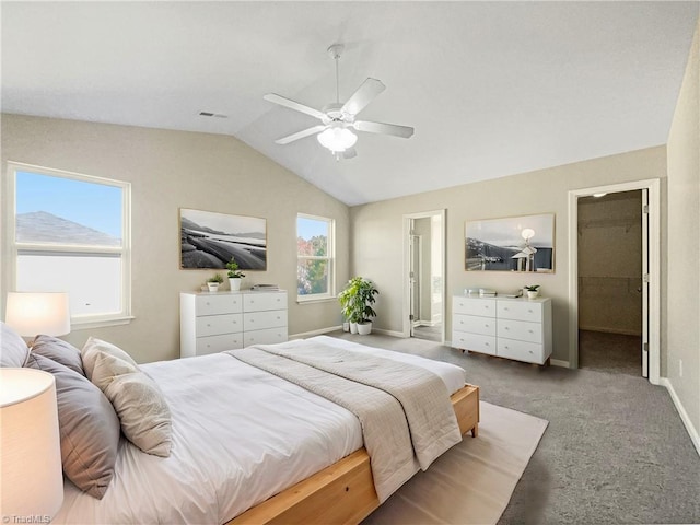 bedroom with lofted ceiling, carpet floors, a spacious closet, and ceiling fan