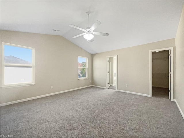 interior space with lofted ceiling, carpet, and ceiling fan