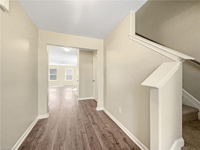 hallway with hardwood / wood-style flooring