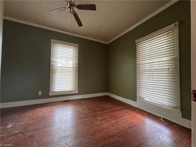 empty room featuring wood-type flooring, a ceiling fan, and baseboards