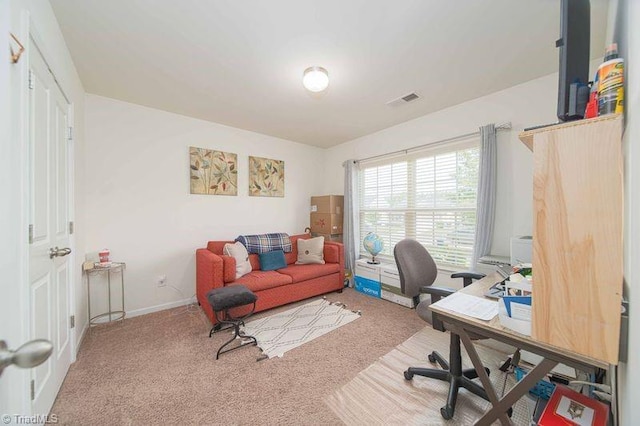 carpeted office featuring baseboards