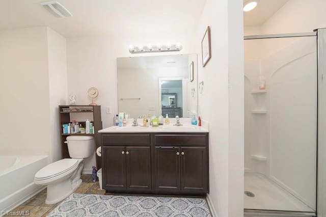full bath with a stall shower, toilet, double vanity, baseboards, and a bath