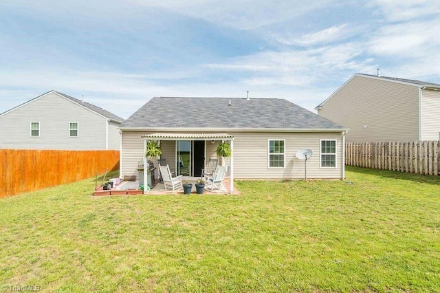 rear view of property featuring a patio and roof with shingles
