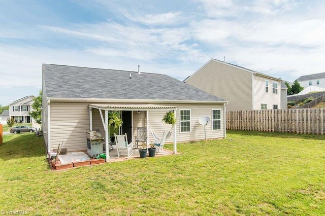 rear view of house with a patio area and a shingled roof