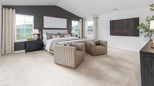 bedroom featuring baseboards, lofted ceiling, and light carpet