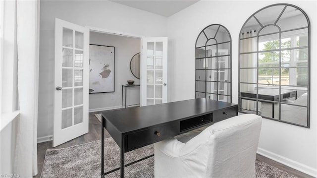 home office with french doors, baseboards, and wood finished floors