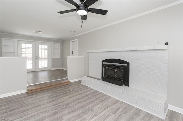 unfurnished living room with ceiling fan, french doors, ornamental molding, and hardwood / wood-style flooring