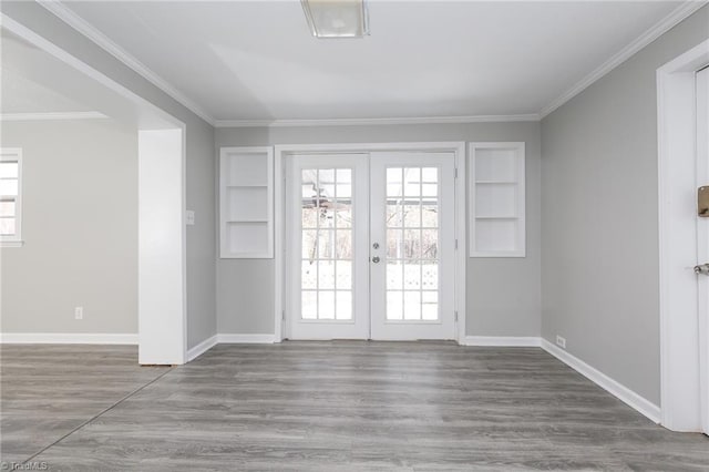 doorway with built in shelves, crown molding, french doors, and hardwood / wood-style floors