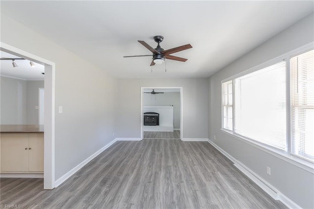 unfurnished living room featuring light hardwood / wood-style flooring and ceiling fan