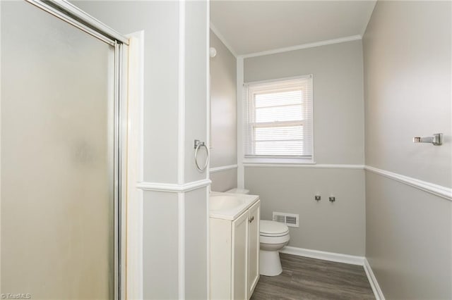 bathroom featuring walk in shower, crown molding, toilet, vanity, and hardwood / wood-style flooring