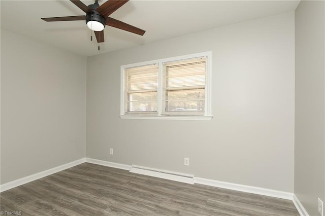 spare room with baseboard heating, ceiling fan, and wood-type flooring