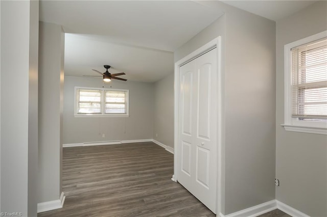 spare room with plenty of natural light, dark wood-type flooring, and ceiling fan