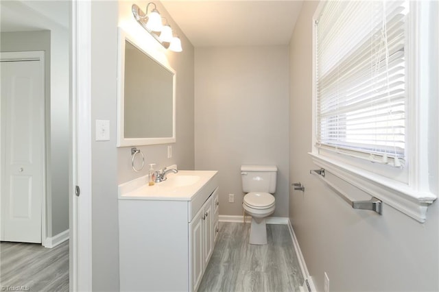 bathroom featuring hardwood / wood-style floors, vanity, and toilet