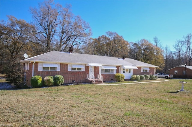 ranch-style home featuring a front yard