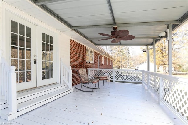 wooden deck with ceiling fan and french doors