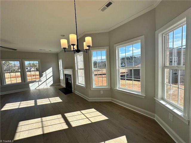 unfurnished dining area with a chandelier, visible vents, baseboards, and a healthy amount of sunlight