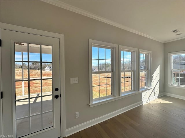 doorway to outside with dark wood-type flooring, visible vents, baseboards, and crown molding