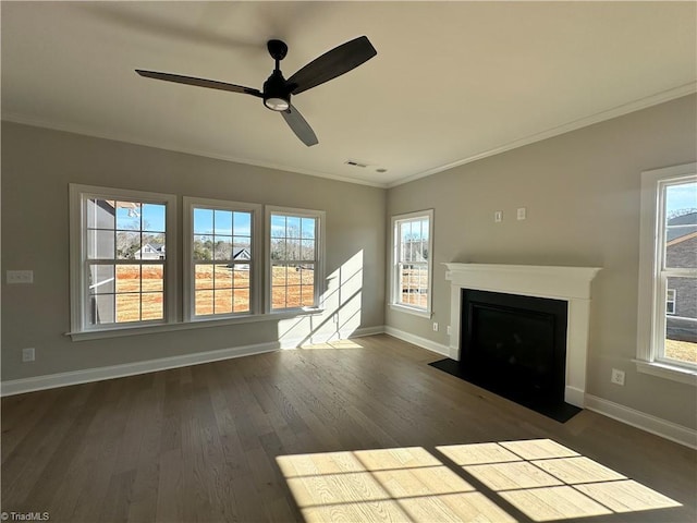 unfurnished living room with crown molding, baseboards, and a healthy amount of sunlight