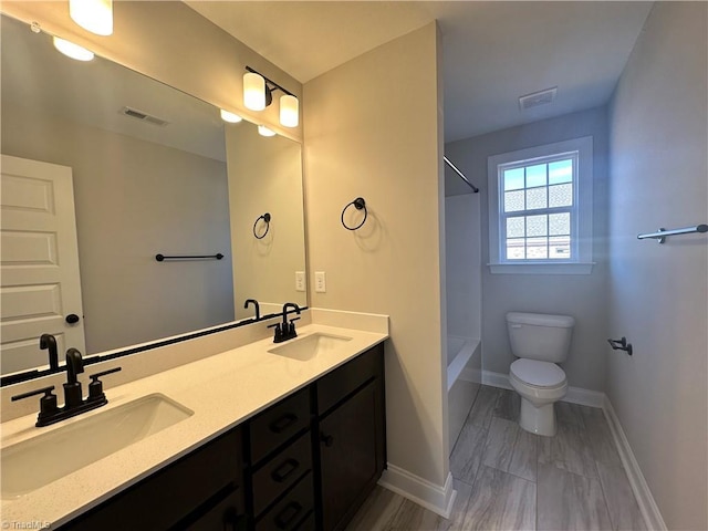 full bath featuring double vanity, visible vents, a sink, and toilet