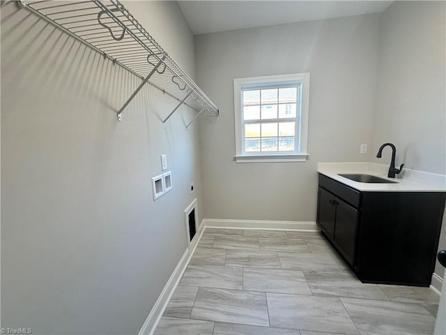 washroom with washer hookup, hookup for an electric dryer, a sink, baseboards, and cabinet space