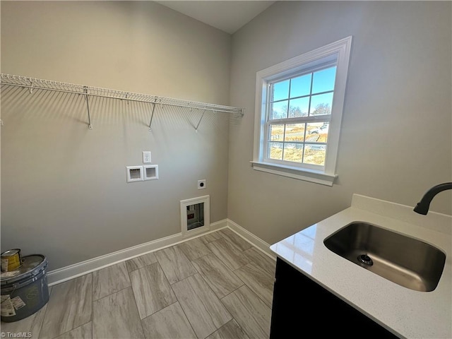 washroom featuring laundry area, washer hookup, a sink, hookup for an electric dryer, and baseboards