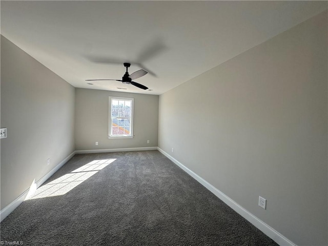 carpeted empty room with ceiling fan and baseboards