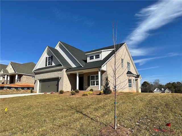 craftsman-style house with brick siding, an attached garage, driveway, and a front lawn