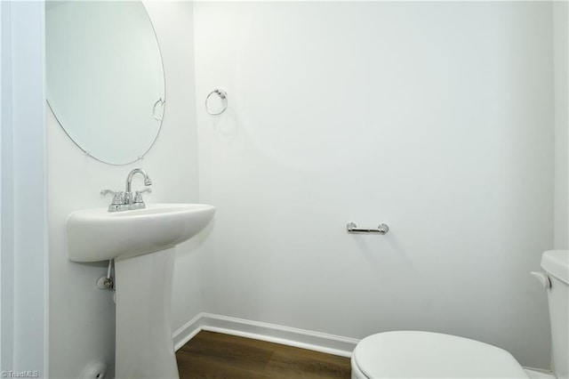 bathroom featuring hardwood / wood-style floors, sink, and toilet